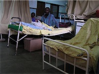 Patient on old bed. Kamazu Central Hospital - Lilongwe, Malawi.